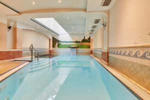 an indoor swimming pool in a hotel with a large ceiling at WAGNERS Hotel im Bayerischen Wald in Grafenau