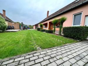a yard of a house with a brick driveway at Ubytovanie Klára in Veľký Meder