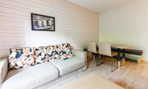 a living room with a couch and a table at Résidence Vacancéole Les Chalets d'Ax in Ax-les-Thermes