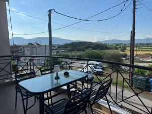a table and chairs on a balcony with a view at Ancient Philippi Luxury Apt MKP in Krinídhes