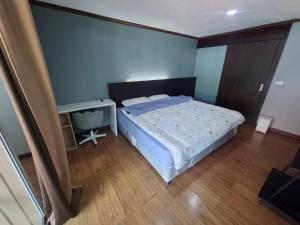 a small bedroom with a bed and a television at Baan Mo in Ban Kata