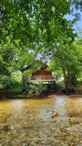 a house sitting on a bridge over a river at Resort Shareula in K'veda Ghvardia +17 photos