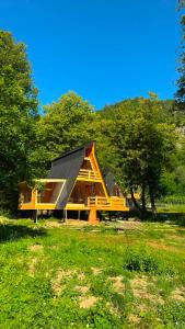 a house with a metal roof in a field at Resort Shareula in K'veda Ghvardia