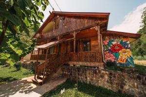 a house with a mural on the side of it at Resort Shareula in K'veda Ghvardia