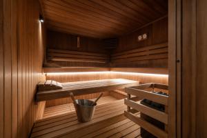 a wooden sauna with a bucket in it at Logis Hotel Center in Brest
