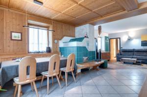 a living room with a table and chairs at Apartments Trettel in Tesero