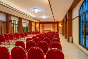 a conference room with red chairs and a table at HOTEL MARIAPARK KALLooRKKAD in Vāzhākulam +13 photos