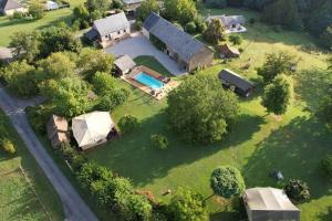 an aerial view of a house with a pool and a yard at Lodge La Vie Douce in Vigeois