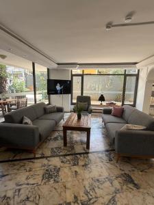 a living room with couches and a table in a room at Cleo Hotel in Alanya