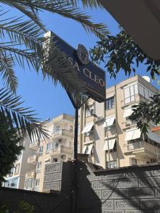 a blue street sign in front of a building at Cleo Hotel in Alanya