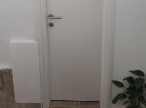 a white door in a room with a plant at Rooms Milena in Lopud +29 photos