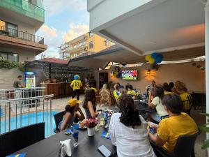 a group of people sitting at tables in a restaurant at Cleo Hotel in Alanya +14 photos