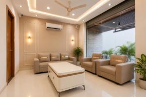 a waiting room with couches and a table at Hotel Shree Near Prem Mandir in Chhatikara