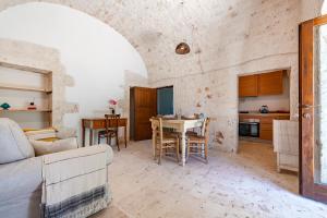 a living room with a couch and a table at Lamia Terra 3BR, Terrace & BBQ - Happy Rentals in Castellana Grotte