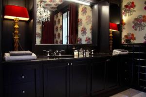 a bathroom with a sink and a mirror at La Maison du Théâtre in Ravenna +24 photos