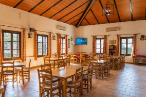 a dining room with wooden tables and chairs at Kampaoh El Rocío in El Rocío