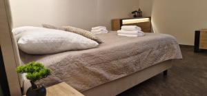 a bedroom with a bed with towels on it at Breakpoint Loft - City Center in Łobez