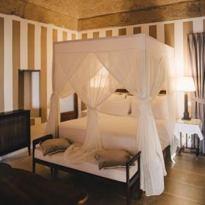 a bedroom with a bed with a canopy at Mà C'a - Casa Privata in Praiano