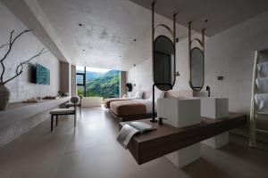a bedroom with a bed and a large mirror at Enjoy nature Be energetic in Yunji