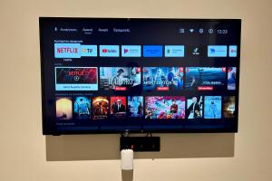 a flat screen tv hanging on a wall at GLEN Premium Stays in Kanali