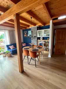 a kitchen and dining room with a table and chairs at Żuławska Osada in Trutnowy
