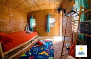 a bedroom with a bed in a small room at Point Calixto beach front hut, Boracay in Boracay +15 photos