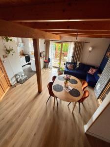 a living room with a table and a couch at Żuławska Osada in Trutnowy