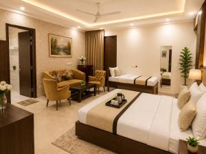 a hotel room with a bed and a living room at Akshay Hotel in Gurgaon