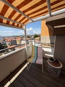 a balcony with a chair and a view of a city at Minià in Pescara