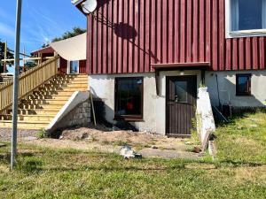 a red and white house with a door and stairs at Sommarboende i centrala Varberg in Varberg