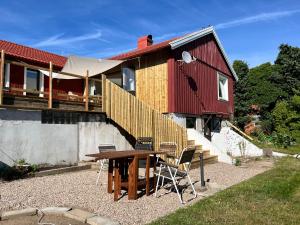 a house with a table and chairs in front of it at Sommarboende i centrala Varberg in Varberg