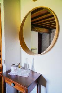 a table with a mirror and a cake on it at Agriturismo La Colombella in Bagni San Filippo