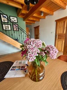 a vase filled with flowers sitting on a table at Żuławska Osada in Trutnowy