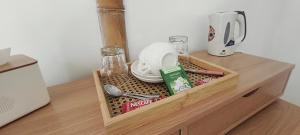 a wooden drawer with a tray of food and a blender at Lokal Hotels Dauin in Dauin