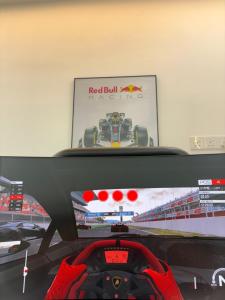 a tv with a racing game on the screen at Chin Villa in Simpang Ampat