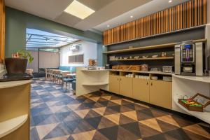 a restaurant with a kitchen and a dining room at Hôtel Icare in Toulouse +97 photos