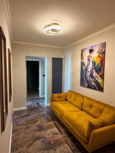 a couch in a living room with a painting on the wall at GZP Residence Lugoj 5 in Lugoj