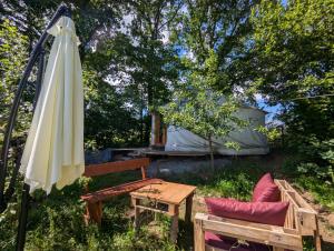 an umbrella and a table and a bench and a tent at Martinická jurta in Martinice u Dolních Kralovic