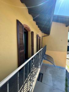 a balcony of a house with wooden doors and a railing at Sosta dei Passeggeri in Roccabruna