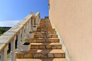 a stone stairway with potted plants on it at Apartman Mara in Pomer
