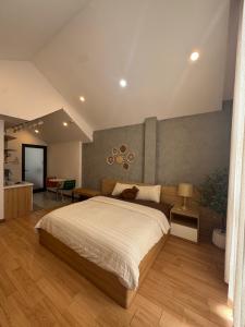 a bedroom with a large bed in a room at Mango Home & Apartment in Danang