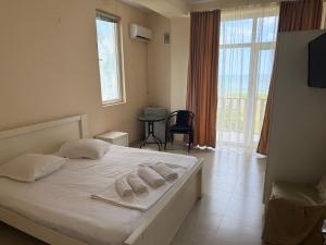 a bedroom with a bed with two pillows on it at LizAna in Shekhvetili