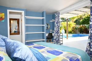 a bedroom with blue walls and a bed at Chalet Kestrel with pool on the beach in Riambel +39 photos