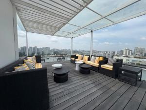 a deck with couches and tables on a building at StayX Sky Garden in Ba Ria