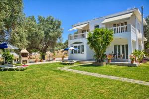 a villa with a yard in front of it at Agathi Sun Set in Rhodes Town