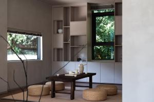 a living room with a table and two windows at Enjoy nature Be energetic in Yunji