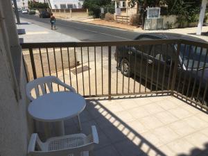 a white table and a chair on a balcony at Mandali Court in Ayia Napa +3 photos