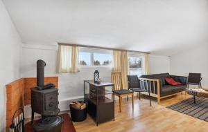a living room with a wood stove and a couch at 2 Bedroom Nice Apartment In Ringkøbing in Ringkøbing