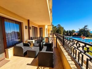a hotel balcony with chairs and a swimming pool at Europroperties Zlatna Kotva Apartments in Golden Sands