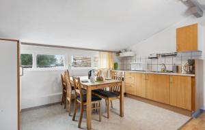 a kitchen with a table and chairs in a room at 2 Bedroom Nice Apartment In Ringkøbing in Ringkøbing